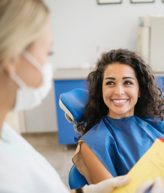 Women Dentist Talking To Patient